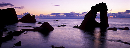 Gaada Stack natural arch, 45 m high, at sunset, Foula, Shetland Islands, Scotland, United Kingdom, Europe