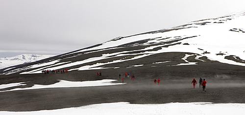 Tourists crossing the mountains that rim the volcanic caldera of Deception Island, South Shetland Islands, Antarctic Peninsula, Antarctica, Polar Regions