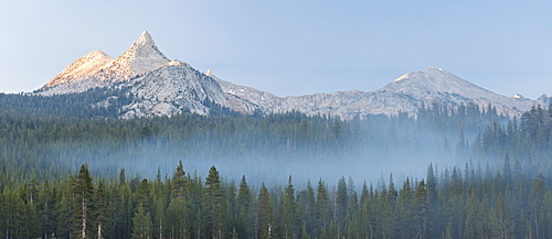 Unicorn Peak mountain above mist shrouded pine forest, Yosemite National Park, UNESCO World Heritage Site, California, United States of America, North America