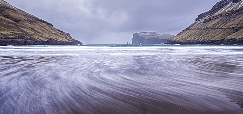 Waves crash against the black sandy beach at Tjornuvik on the island of Streymoy, Faroe Islands, Denmark, Europe