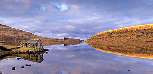 Stone boathouse on the shores of Lake Sorvagur on the island of Vagar, Faroe Islands, Denmark, Europe