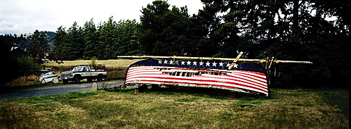 Upturned derelict boat with stars and stripes painted on hull, Washington state, United States of America, North America