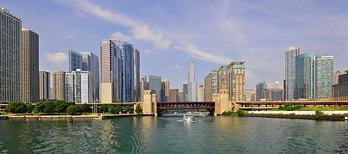 Excursion boat in front of the bridge on North Lakeshore Drive crossing the Chicago River, behind, the skyline with Trump International Tower, 3 Illinois Center, Swissotel and the Aqua Building, Chicago, Illinois, United States of America, USA