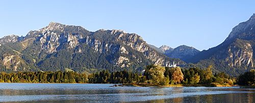 Mt Tegelberg and Neuschwanstein Castle overlooking Forggensee lake, near Fussen, Ammer Mountains, Ostallgaeu, Swabia, Bavaria, Germany, Europe