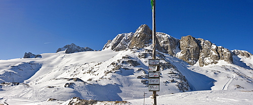 Left to right: Mts. Dirndln, Hoher Dachstein, Niederer Dachstein and, behind the directional signpost, Mt. Schoeberl, Dachstein Massif, Styria, Austria, Europe