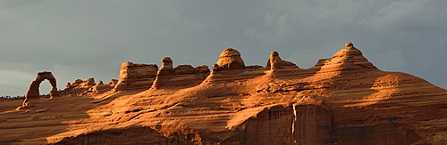 Panoramic shot, stormy atmosphere, tourists at Delicate Arch, Arches National Park, Moab, Utah, United States of America, USA