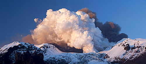 Panoramic shot of two clouds from the volcanic eruption in Eyjafjallajoekull Volcano, the black cloud at the rear is coming from the crater, the white cloud at the front is the result of a lava flow in a glacier, Eyjafjallajoekull, Iceland, Europe