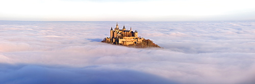 Burg Hohenzollern castle in morning light, mist, with autumn forest, Schwaebische Alb, Swabian Alb, Baden-Wuerttemberg, Germany, Europe