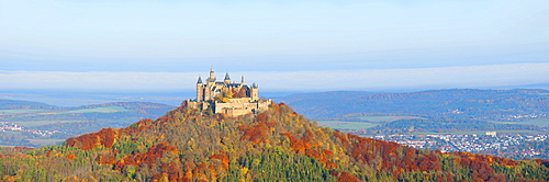 Burg Hohenzollern Castle in the early morning light and fog, with autumnal forest, Swabian Alb, Baden-Wuerttemberg, Germany, Europe