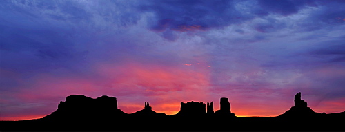 Panoramic view, sunrise, dawn, mesas of Brigham's Tomb, King on His Throne, Stagecoach, Bear and Rabbit, Castle Butte, Big Indian, Monument Valley, Navajo Tribal Park, Navajo Nation Reservation, Arizona, Utah, United States of America, USA