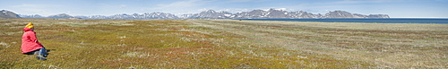 Woman tourist sitting, Grand Vista, peninsual coast, Gabriel Bay, Chukotka Peninsular, Russia, Asia