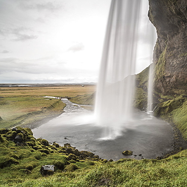 Behind Seljalandsfoss, a famous waterfall just off route 1 in South Iceland (Sudurland), Iceland, Polar Regions