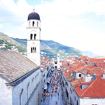 View along main street Stradun with Franciscan monastery, mountains in background, Dubrovnik, Dalmatia, Croatia