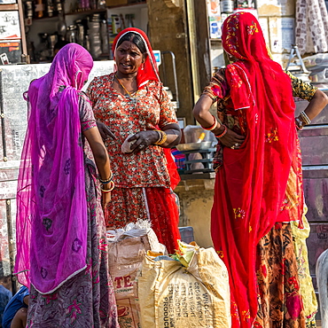 Three Indian women talking outside a shop, Jaisalmer, Rajasthan, India