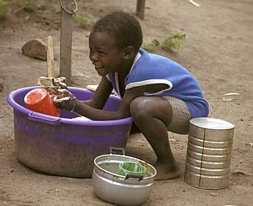 Rwanda boy washing dishes, mwisale