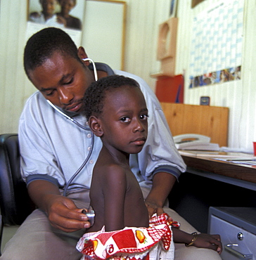 Tanzania doctor examining child at the posada clinic, dar-es-salaam.