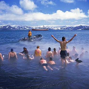 Tourists bathe in hot tub in warm waters of dormant volcano on Deception Island, Antarctica, Polar Regions