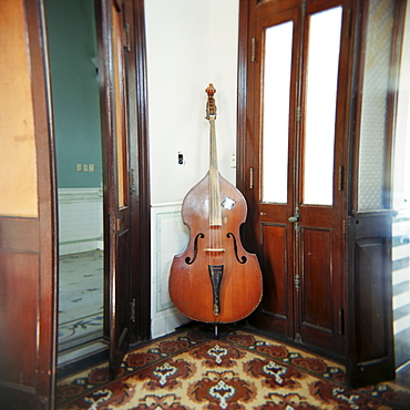 Double bass propped against a wall, Cienfuegos, Cuba, West Indies, Central America