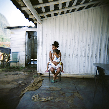 Mother and daughter on porch of their farm, Vinales, Cuba, West Indies, Central America