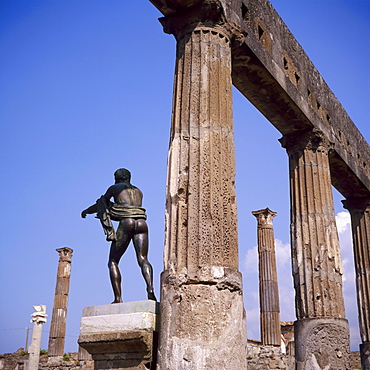 Columns and statue at the archaeological site of Pompeii in Campania, Italy 