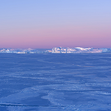 Sunrise during winter at the Ilulissat Icefjord, located in the Disko Bay in West Greenland, the Icefjord is part of the UNESCO world heritage. America, North America, Greenland, Denmark