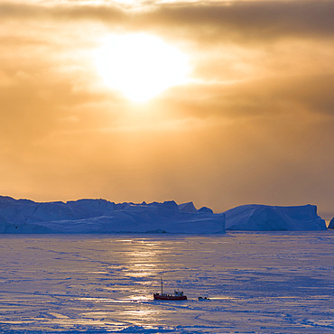 Fishing boats. Winter at the Ilulissat Icefjord, located in the Disko Bay in West Greenland, the Icefjord is part of the UNESCO world heritage. America, North America, Greenland, Denmark