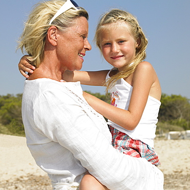 Grandmother and grandaughter (6-8) on beach