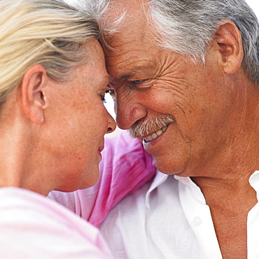 senior couple embracing outdoors, close-up