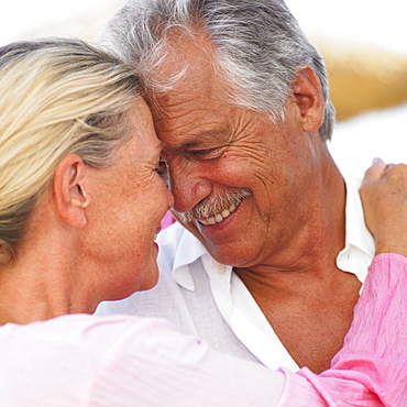 senior couple embracing outdoors, close-up