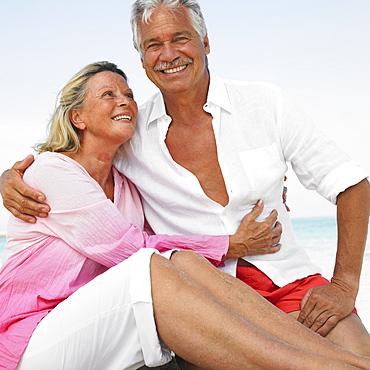 senior couple on beach embracing