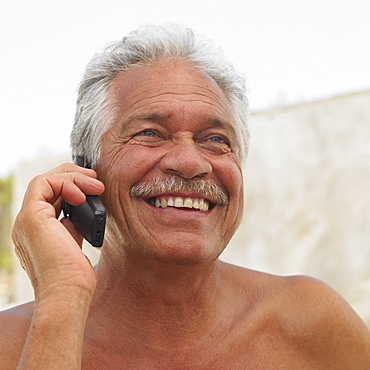 Senior man on mobile phone outdoors