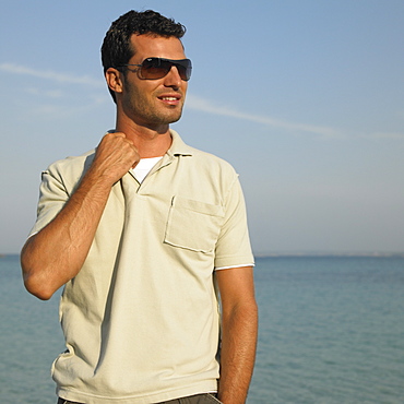 Man on beach wearing sunglasses