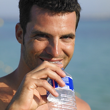 Man drinking from water bottle, close-up