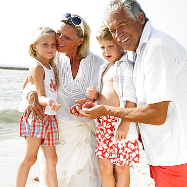 Grandparents and grandchildren (6-8) on beach