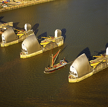 Aerial image of Thames sailing barge and Thames Flood Barrier across the River Thames, Woolwich Reach, Woolwich, London, England, United Kingdom, Europe