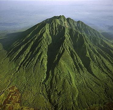 Aerial view of Mount Sabyinyo, an extinct volcano and oldest of the Virunga Mountains, the summit at 3645ï¾ metres marks the intersection of the borders of Democratic Republic of the Congo (DRC), Rwanda, and Uganda, Virunga Volcanoes, Africa