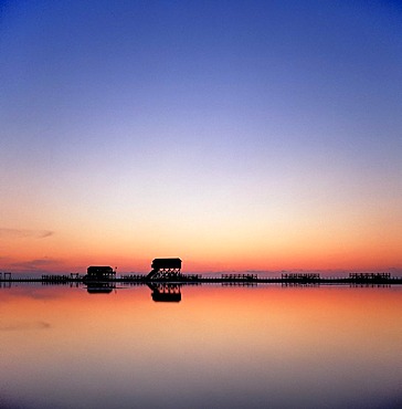 Buildings on stilts at dusk in the North Sea Watt, St Peter Ording, North Frisian, Schleswig-Holstein, Northern Germany, Germany, Europe