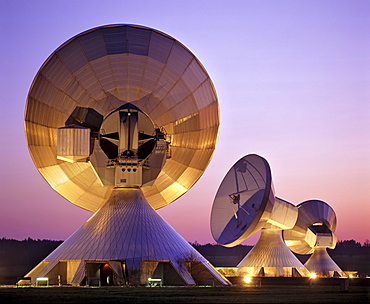 Dusk, lit antennas of the ground communication station Raisting, Upper Bavaria, Germany