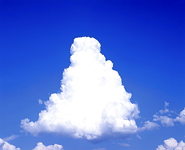 Pyramid-shaped cumulus cloud in a blue sky