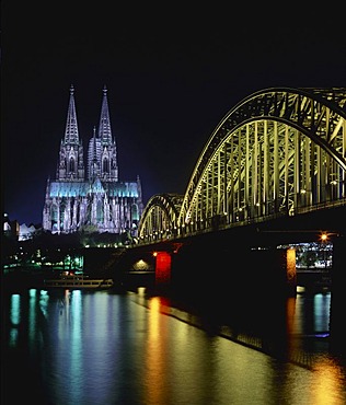 Arches of Deutz Bridge crossing the Rhine River in front of Cologne Cathedral at night, Cologne, North Rhine-Westphalia, Germany, Europe