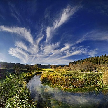 Bizarre cloudforms reflected in the idyllic little creek of Morsbach, Altmuehltal Nature Park near Emsing, Bavaria, Germany, Europe