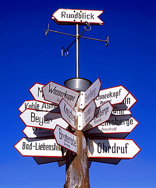 signs hiking guide on tree trunk Berggasthof auf dem Grossen Inselsberg Thuringen Deutschland