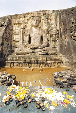 Seated Buddha statue with offerings, Polonnaruwa, Sri Lanka