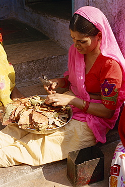 Woman cutting leaves for betel nut chew, Jodhpur, Rajasthan state, India, Asia