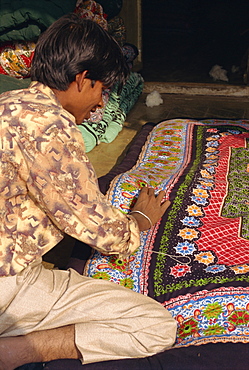 Young man sewing quilt, Dhariyawad, Rajasthan state, India, Asia