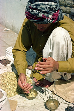 Man using scales, Karachi, Pakistan, Asia