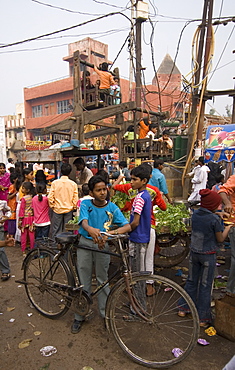 Children playing on wooden merry-go-round, Agra, Uttar Pradesh, India