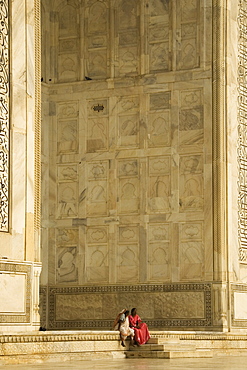 Two elderly ladies gossiping on steps of Taj Mahal tomb, Agra, Uttar Pradesh, India