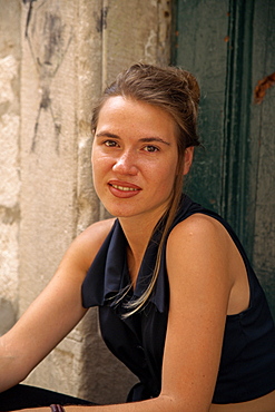 Portrait of a young woman shopkeeper wearing black sleeveless dress, in Dubrovnik, Croatia, Europe