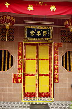 Close-up of a bright red and yellow door to a restored Chinese home on Koon Seng Road in Singapore, Southeast Asia, Asia